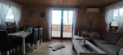 a living room with a couch and a table at Relaksówka in Roztoka