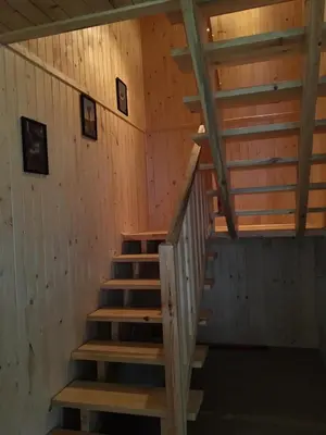 a staircase in a cabin with wood paneling at Relaksówka in Roztoka