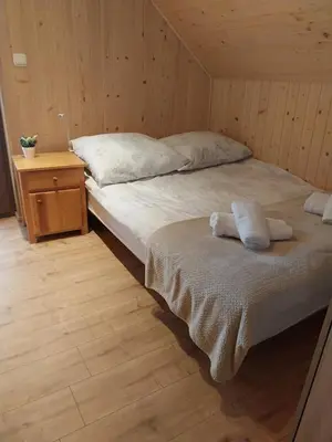 a bedroom with a bed with two towels on it at Relaksówka in Roztoka
