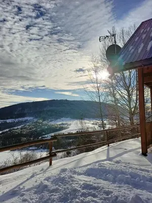 a snow covered balcony with a view of a valley at Relaksówka in Roztoka