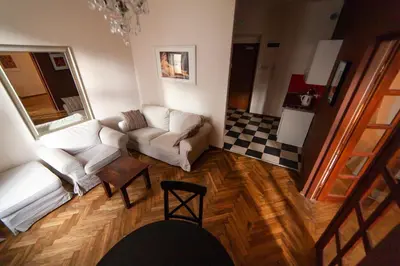 a room with two beds and a table and a couch at Lounge Apartments in Kraków