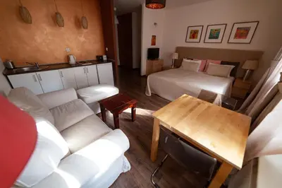 a hotel room with a bed and a couch at Lounge Apartments in Kraków