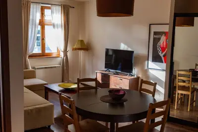 a living room with a couch and a table at Lounge Apartments in Kraków