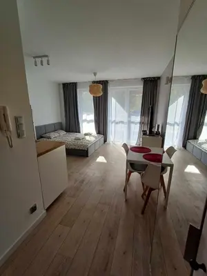a large living room with a bed and a table at Wielicka Apartment 3 in Kraków