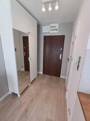 an empty room with a door and a wooden floor at Wielicka Apartment 3 in Kraków