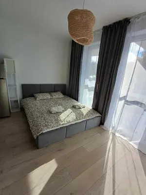 a bedroom with a bed and a large window at Wielicka Apartment 3 in Kraków