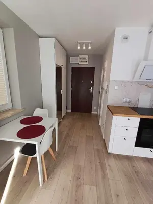 a kitchen with a white table and a white table and a kitchen sidx sidx sidx at Wielicka Apartment 3 in Kraków
