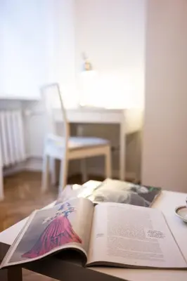 an open book sitting on top of a table at Native Apartments Skawińska 5 in Kraków