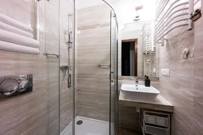 a bathroom with a glass shower and a sink at Native Apartments Skawińska 5 in Kraków