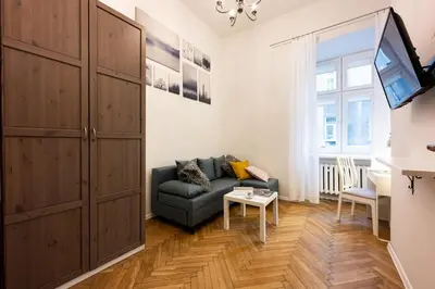 a living room with a couch and a tv at Native Apartments Skawińska 5 in Kraków
