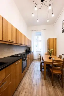 a kitchen with a table and a dining room at Native Apartments Skawińska 5 in Kraków