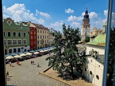 a city with a tree in the middle of a street at Royal Palace from the 14th century - 125 m2 in Kraków