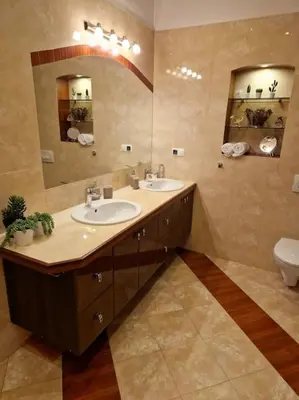 a bathroom with two sinks and a mirror and a toilet at Royal Palace from the 14th century - 125 m2 in Kraków
