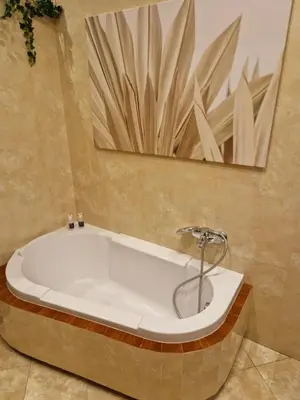 a bath tub in a bathroom with a mirror at Royal Palace from the 14th century - 125 m2 in Kraków