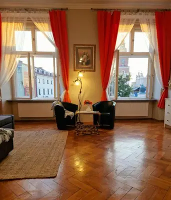 a living room with red curtains and a table and chairs at Royal Palace from the 14th century - 125 m2 in Kraków