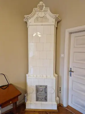 a white fireplace in a room next to a door at Royal Palace from the 14th century - 125 m2 in Kraków