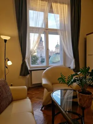 a living room with a couch and a table and a window at Royal Palace from the 14th century - 125 m2 in Kraków