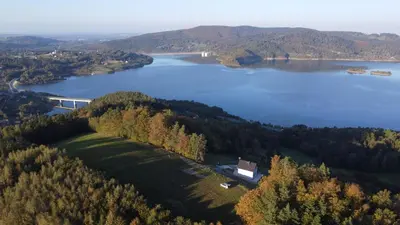 an aerial view of a lake with a train on it at Domek Leo's House in Jaszczurowa