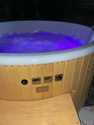 a purple bath tub sitting on top of a wooden shelf at Domek Leo's House in Jaszczurowa