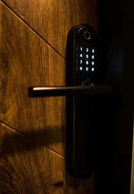 a black cell phone sitting on a wooden door at Apartamenty W Centrum Chrzanowa in Chrzanów