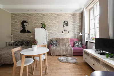 a living room with a couch and a table at Negroni Apartments Plac Nowy in Kraków