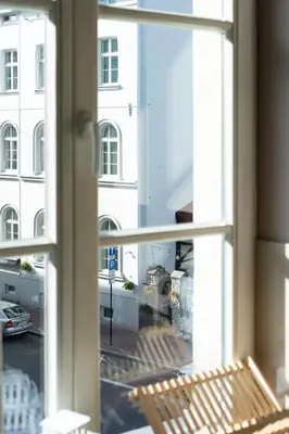 a window with a view of a white building at Negroni Apartments Plac Nowy in Kraków