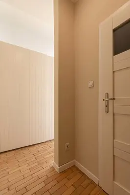 an empty room with a door and a floor at Negroni Apartments Plac Nowy in Kraków