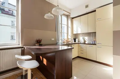 a kitchen with a island with a counter top at Negroni Apartments Plac Nowy in Kraków