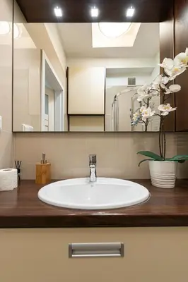 a bathroom with a sink and a mirror at Negroni Apartments Plac Nowy in Kraków
