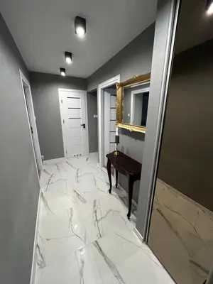 a room with a marble floor with a mirror and a piano at Apartament ,,Eden” in Zator