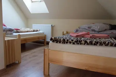 two twin beds in a room with a skylight at Agroturystyka Podzamcze in Krzeszowice