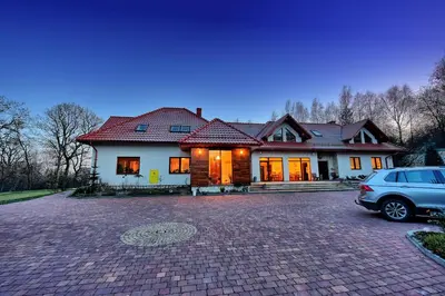a house with a car parked in front of it at Agroturystyka Podzamcze in Krzeszowice