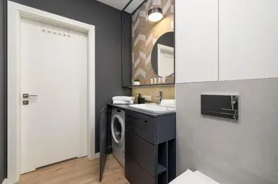 a laundry room with a sink and a washing machine at GO Apartments Studio with Balcony Rakowicka Cracow by Noclegi Renters in Kraków