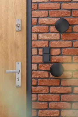 an open door and a brick wall with a sensor at GO Apartments Studio with Balcony Rakowicka Cracow by Noclegi Renters in Kraków