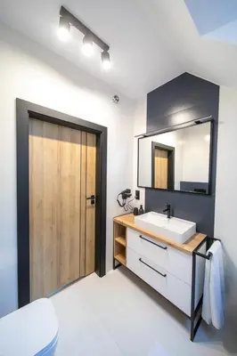 a bathroom with a sink and a mirror at Błaż Apart in Laskowa