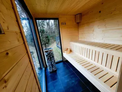 an inside view of a wooden sauna with a window at Błaż Apart in Laskowa