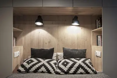 a bedroom with a bed with two pillows and two lights at Charming Apartment with Garden, only 1 km to Wawel Castle by Noclegi Renters in Kraków