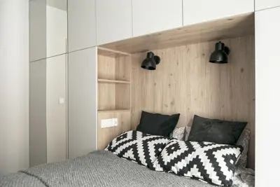 a bedroom with a bed and two black lights at Charming Apartment with Garden, only 1 km to Wawel Castle by Noclegi Renters in Kraków