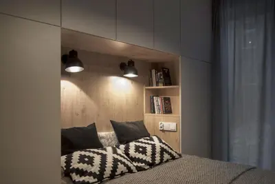 a bedroom with a bed with a built in book shelf at Charming Apartment with Garden, only 1 km to Wawel Castle by Noclegi Renters in Kraków