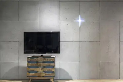 a television and a star on a wall at Charming Apartment with Garden, only 1 km to Wawel Castle by Noclegi Renters in Kraków