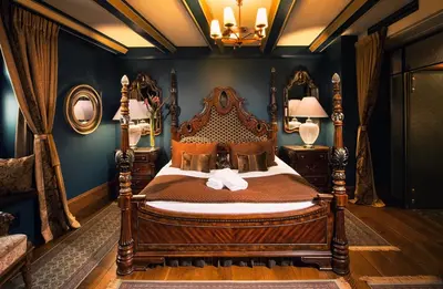 a bedroom with a wooden bed in a room at Kanonicza 22 in Kraków