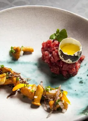 a plate of food with an egg on top at Kanonicza 22 in Kraków