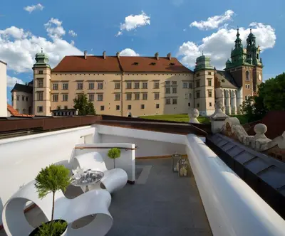 a view of a castle from the roof of a building at Kanonicza 22 in Kraków