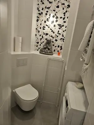 a white bathroom with a toilet and a window at Juwel Apartments Kraków 14 in Kraków
