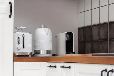 a kitchen with a counter top with a coffee maker at Kraków Comfort Loft Apartments by Rentujemy in Kraków