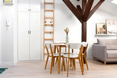 a dining room with a table and chairs at Kraków Comfort Loft Apartments by Rentujemy in Kraków