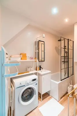 a laundry room with a washing machine and a sink at Kraków Comfort Loft Apartments by Rentujemy in Kraków