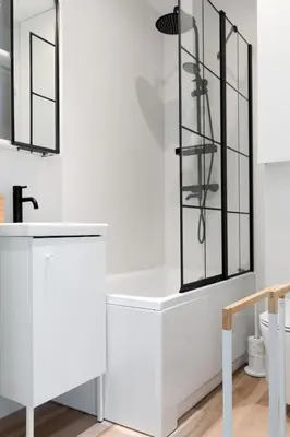 a white bathroom with a sink and a mirror at Kraków Comfort Loft Apartments by Rentujemy in Kraków