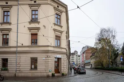 a large white building on a city street at Kraków Comfort Loft Apartments by Rentujemy in Kraków