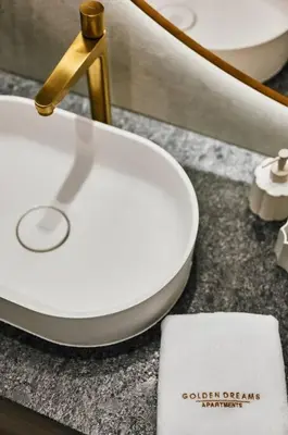 a bathroom with a white toilet and a sink at Golden Dreams Luxury Apartments 103 in Kraków